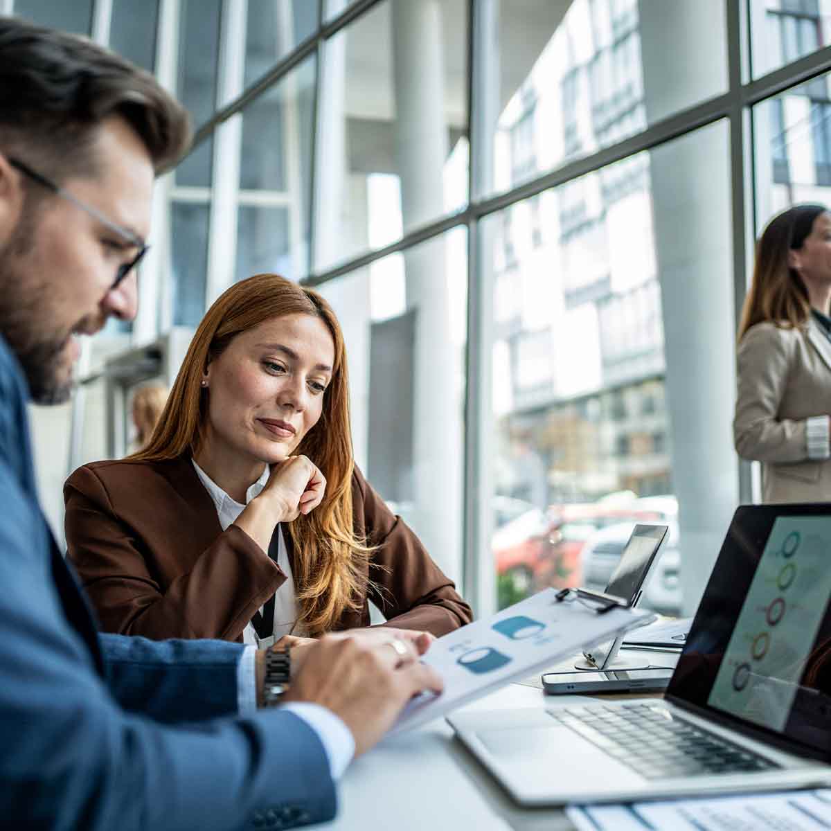 A team reviews charts showing market data to uncover trends
