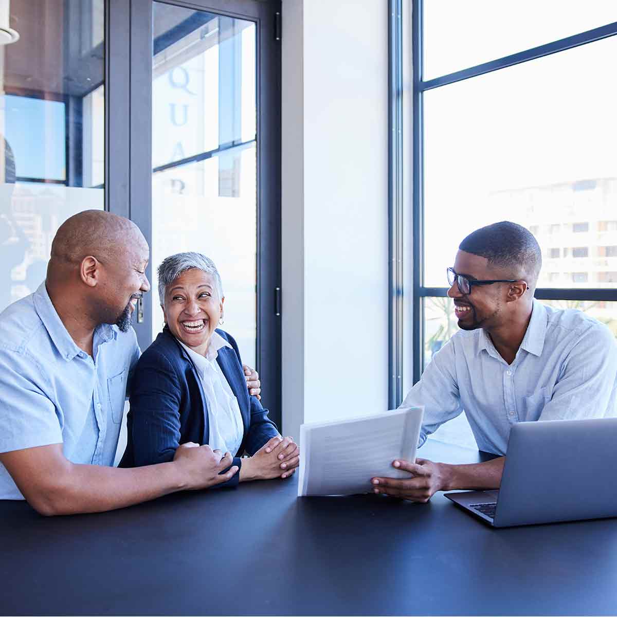 Financial advisor meeting with a couple to review their long-term investment plan