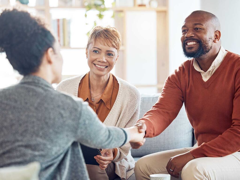 A financial advisor meets with a couple in their home