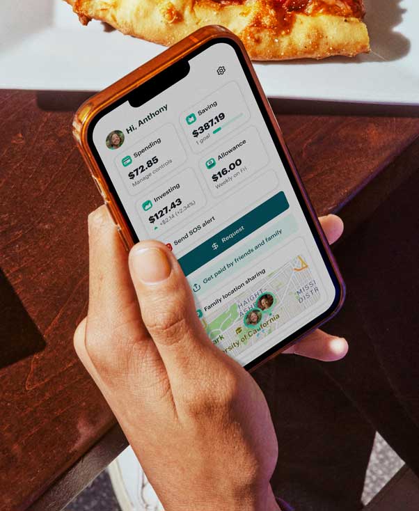 A teenager using the Greenlight kid's debit card app to buy pizza