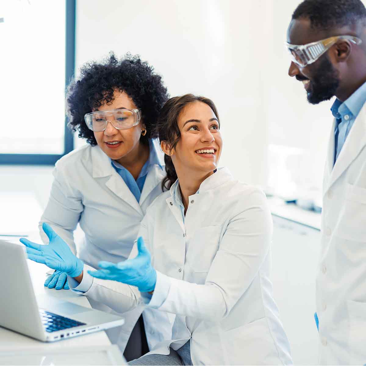 Researchers reviewing data and discussing results in a biotech laboratory