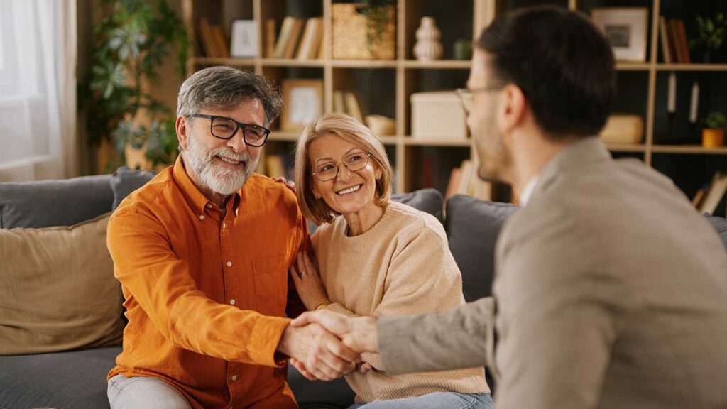 A couple meeting with a banker to discuss savings and financial plans